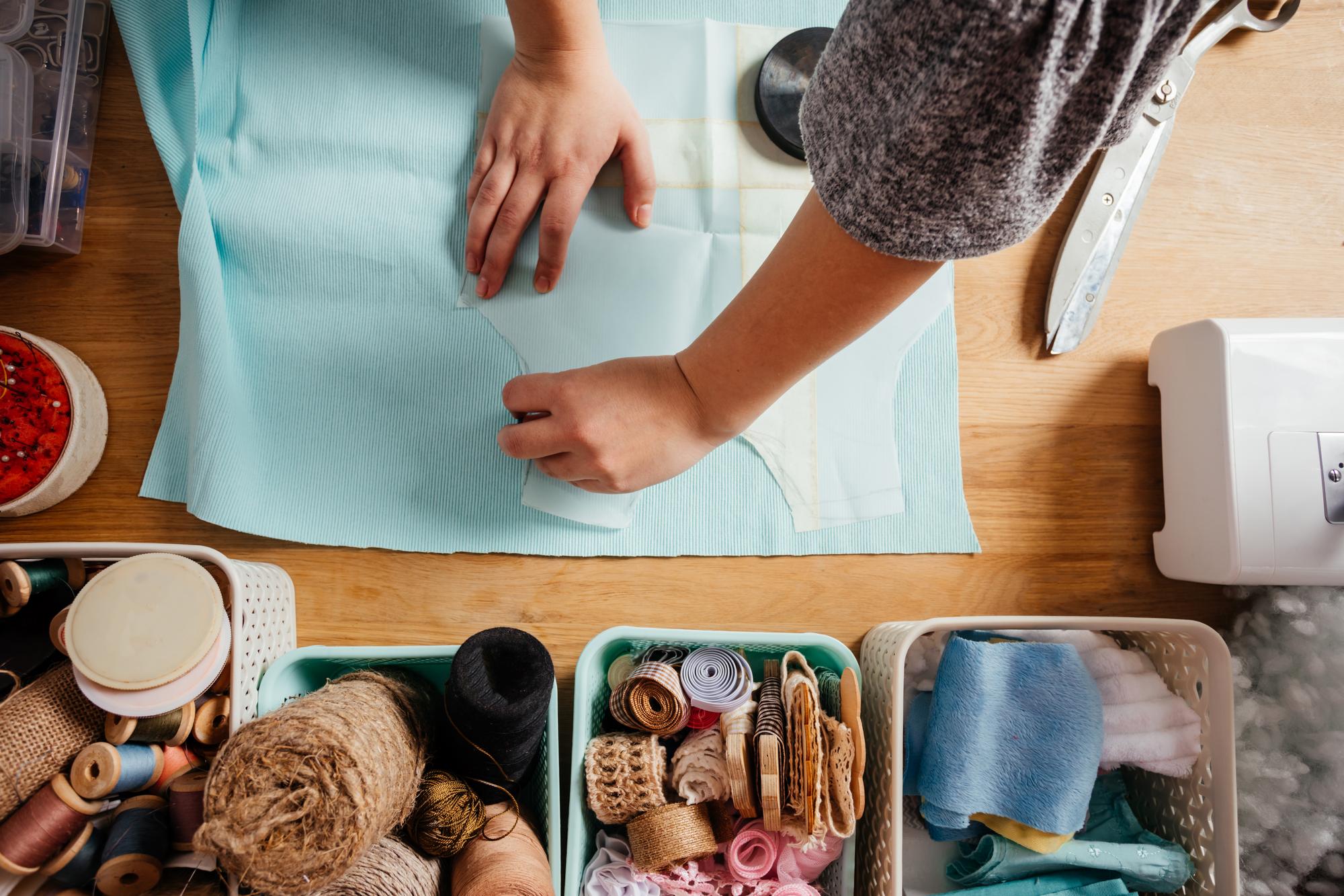 Hand embroiderer at workbench with tools